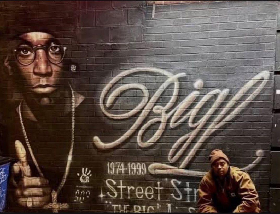 Harlem memorial mural with a painted portrait and script lettering